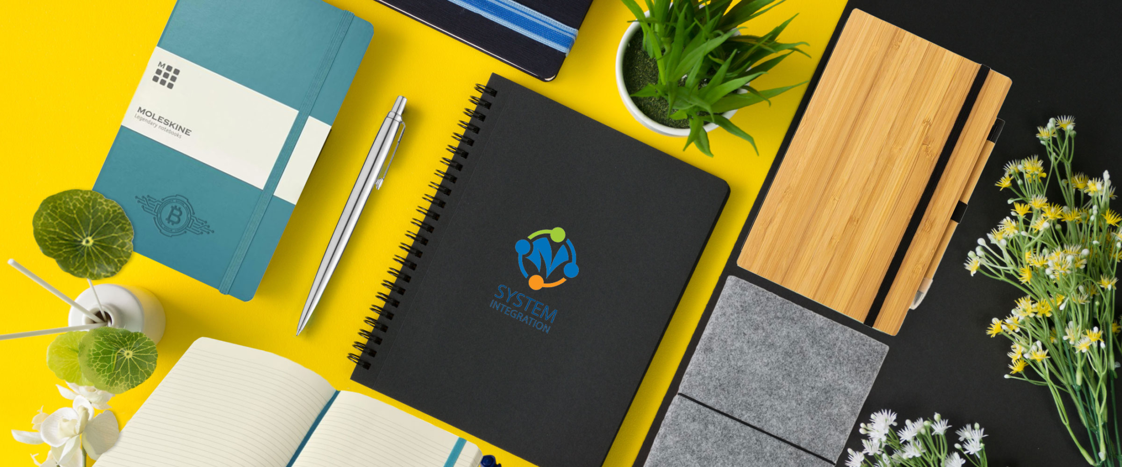 Image showing branded notebooks on a yellow coloured desktop from The Notebook Warehouse, the site for your next company branded notebook.
